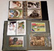 Two postcard albums with in excess of 100 cards in