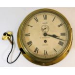 An early 20thC. brass bulkhead clock by maker H. W