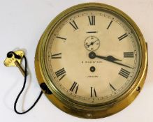 An early 20thC. brass bulkhead clock by maker H. W