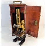 An antique mahogany cased brass microscope with Ba