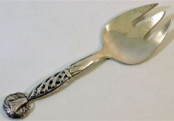 A Georg Jensen silver serving fork with hollow fre