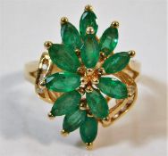 A 14ct ring of organic set with diamond & emerald
