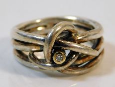 A silver Celtic style ring with gold mounted diamo