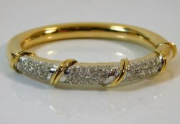 An 18ct gold bangle set with approx. 3ct diamonds