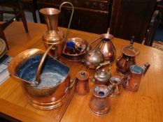 A copper coal bucket twinned with other copperware