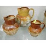 A Doulton stoneware jug & two other stoneware jugs