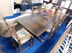 An extending oak Ercol dining table with four chai