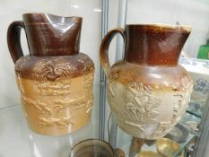 Two stoneware hunting jugs, tallest 9in