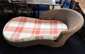 A conservatory wicker chaise longue