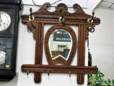 A decorative hall mirror with horseshoe framed mir