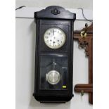 A 1920's oak cased wall clock 30in tall