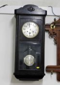 A 1920's oak cased wall clock 30in tall