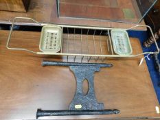 A vintage extendable brass bath caddy twinned with