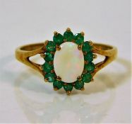 A 9ct gold ring set with emerald & opals size R/S