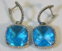 A pair of 14ct white gold earrings set with diamon