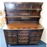 An Ercol dresser with cupboards, shelves & drawers