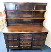 An Ercol dresser with cupboards, shelves & drawers