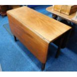 An antique mahogany drop leaf table