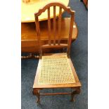 A cane bedroom chair with cabriole style legs