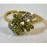 A 9ct gold ring set with green & white stones size