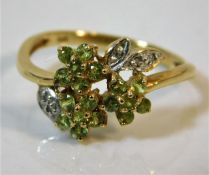 A 9ct gold ring set with green & white stones size