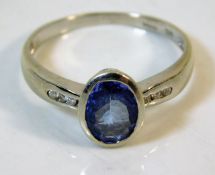 A 9ct white gold ring set with diamond & tanzanite