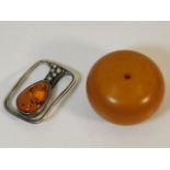 A white metal & amber brooch with a large amber st