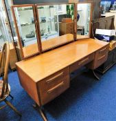 A G-Plan teak dressing table with mirrors 53.5in w