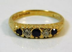 An 18ct gold ring set with diamond & sapphire size