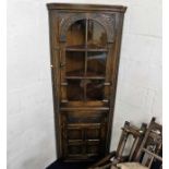 A glazed oak corner cabinet, possibly Ercol 72in h