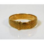 An 18ct gold buckle ring, rubbed marks size Q/R 2.