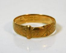 An 18ct gold buckle ring, rubbed marks size Q/R 2.