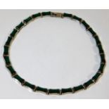 A white metal necklace set with malachite approx.