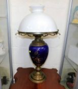 A brass & ceramic oil lamp with glass shade