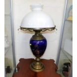 A brass & ceramic oil lamp with glass shade