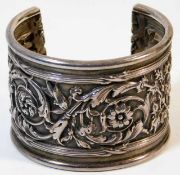 A white metal bangle with relief decor