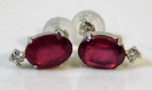 A pair of platinum earrings set with approx. 2ct ruby total & diamonds 1g