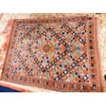 A Persian style rug 85in long x 66in wide