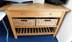 An oak kitchen sideboard with drawers, wicker bask