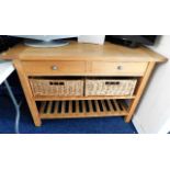 An oak kitchen sideboard with drawers, wicker bask