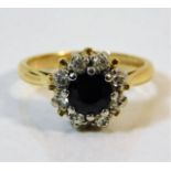 An 18ct gold ring set with diamond & sapphire size