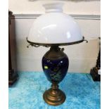 A brass & ceramic oil lamp with glass shade