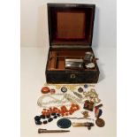 A vintage jewellery box with contents including a