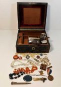 A vintage jewellery box with contents including a