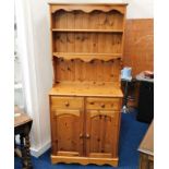 A small cottage style pine dresser with two shelve