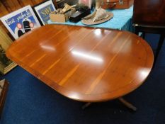 An extendable yew wood Regency style pedestal tabl