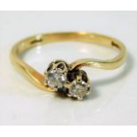 A 9ct gold crossover ring set with 0.15ct diamonds