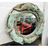 A decorative mirror with carp decor 19in diameter