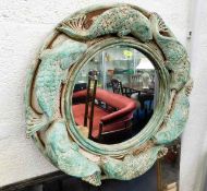 A decorative mirror with carp decor 19in diameter