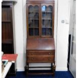 An oak bureau bookcase with glazed doors 75in high